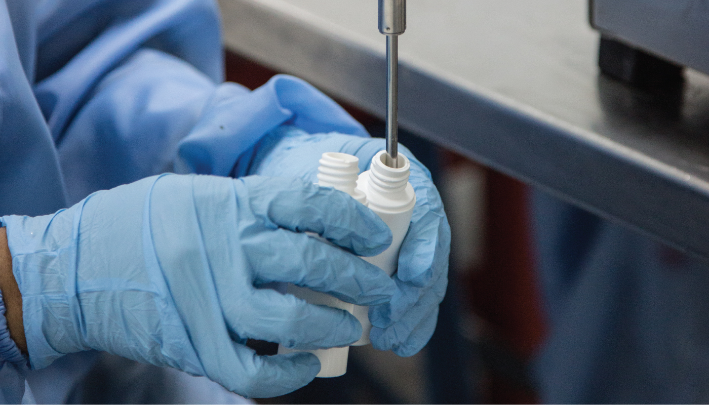 Automated cosmetic jar and bottle filling machine in cleanroom environment